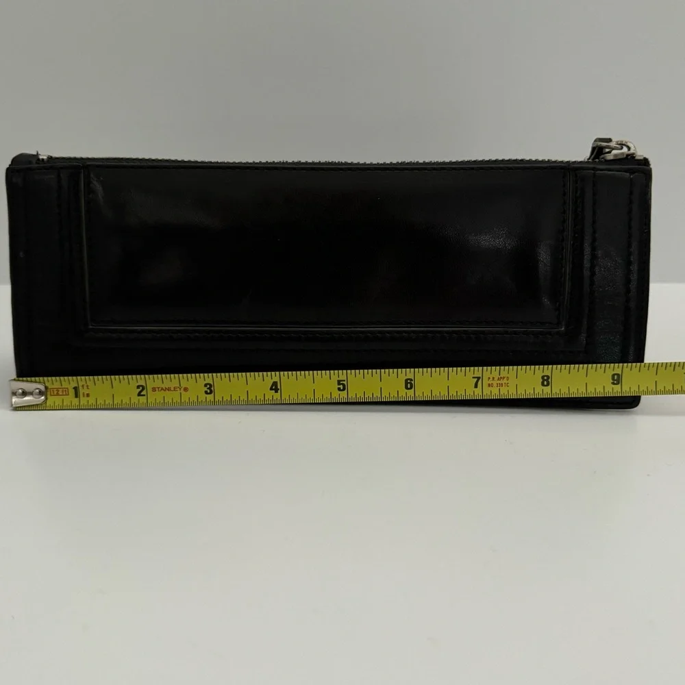Ellen Tracy Black Leather Clutch with red logo interior.